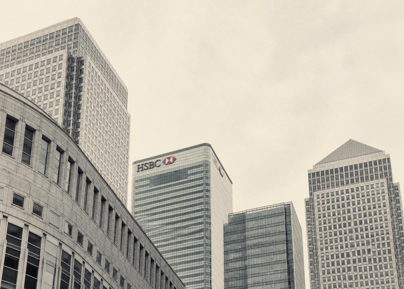 Canary Wharf towers under a pale overcast London sky
